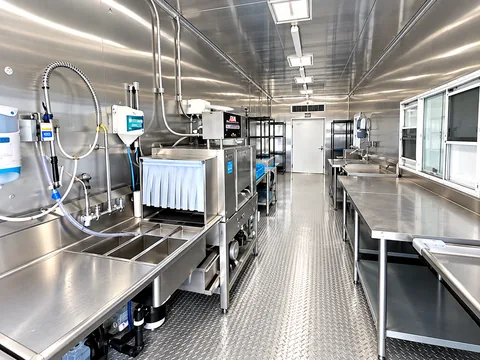 Commercial dishwashing equipment and stainless sinks inside a mobile trailer